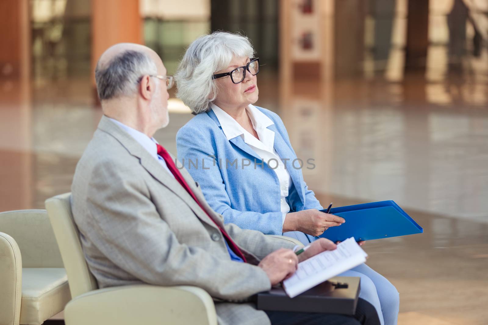 Senior couple meeting real estate agent. Senior couple meeting financial advisor for investment. Happy mature man and woman listening to various investment plans for their retirement.