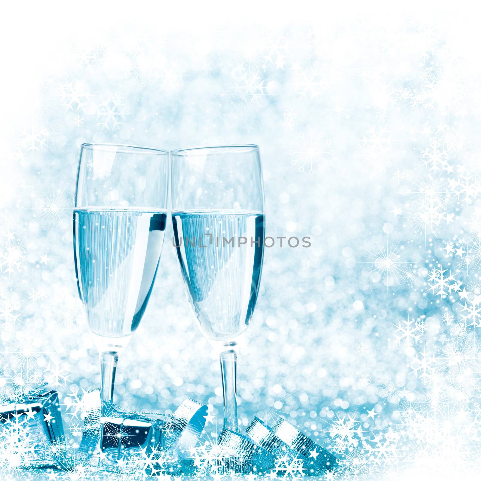 Glasses of champagne and silver gifts on glitter background