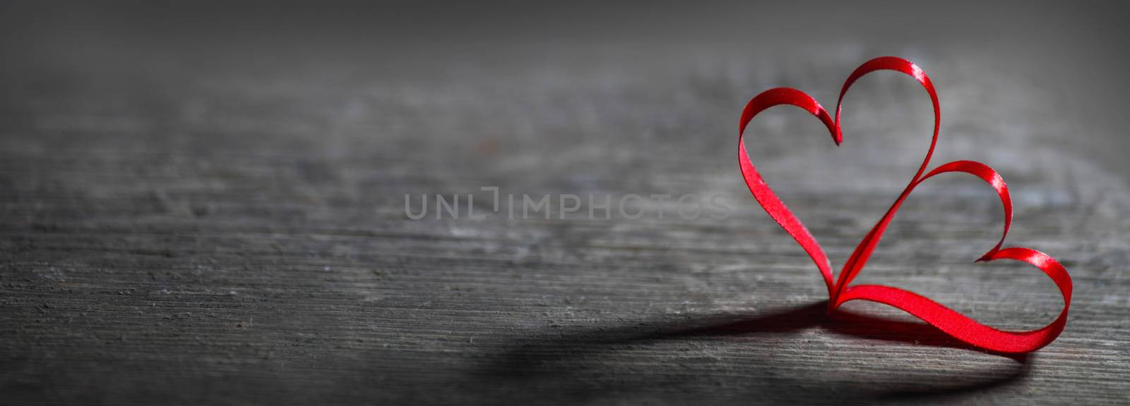 Two red ribbon hearts on wooden backround, Valentine day concept