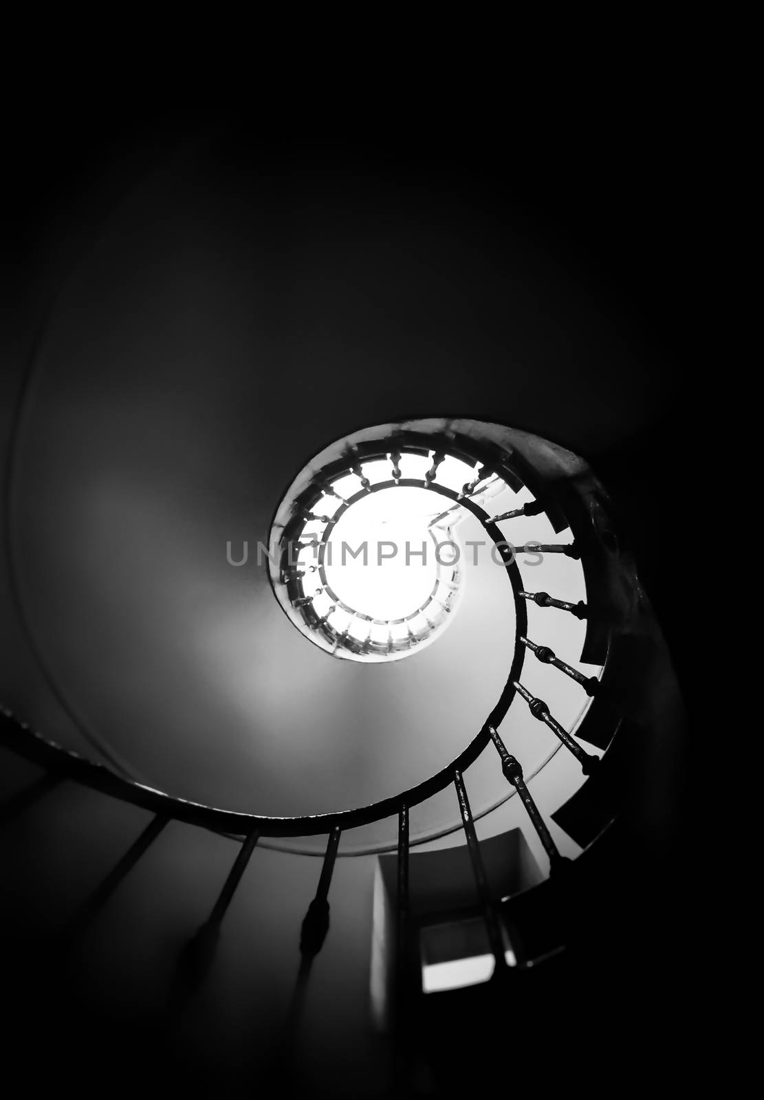 Ancient spiral staircase seen from below. Black and white shot