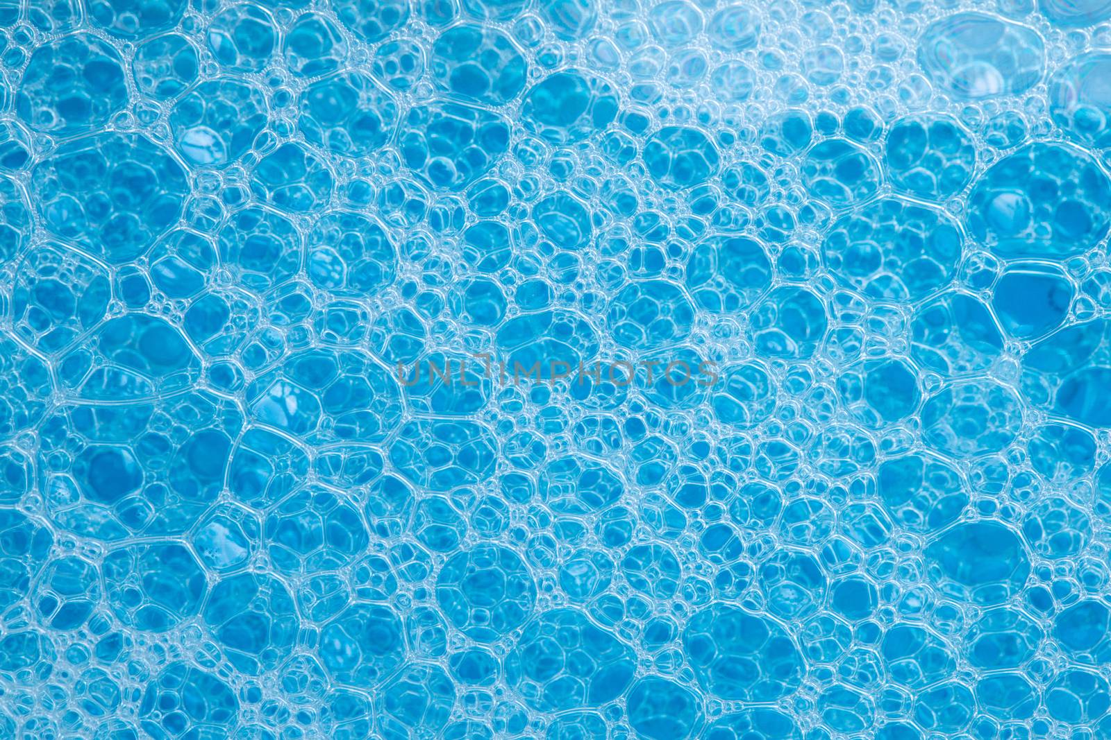 abstract background texture of blue soap foam closeup