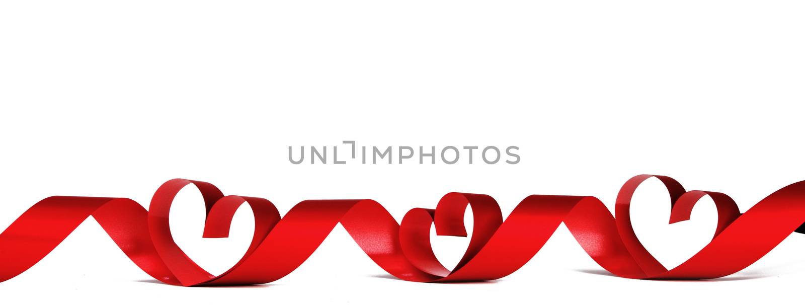 Valentines day frmae made of red ribbon hearts, isolated on white