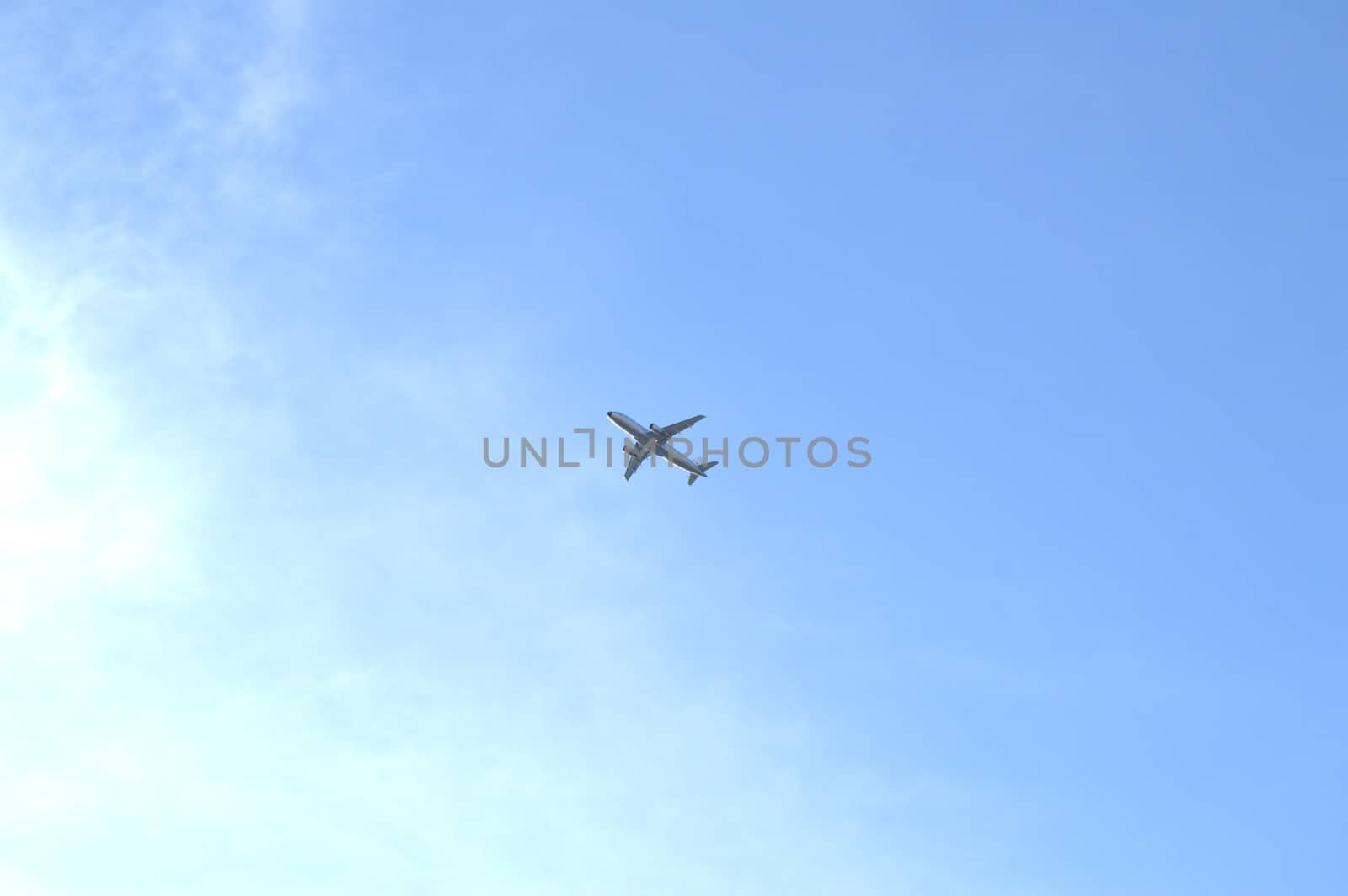 Plane flying in blue sky, travel concept, Empty copy space. by claire_lucia