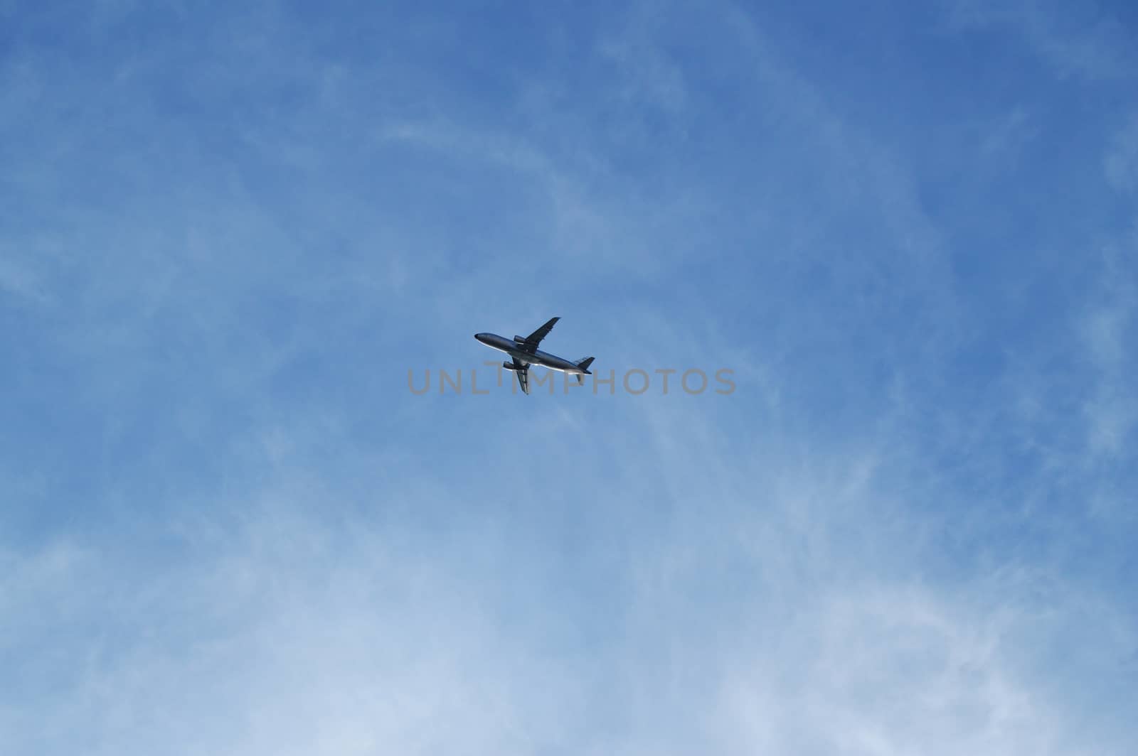 Plane flying in blue sky, travel concept, Empty copy space. by claire_lucia