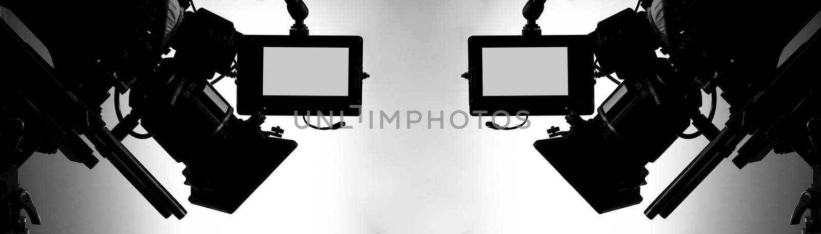 Silhouette images of video camera in tv commercial studio produc by gnepphoto