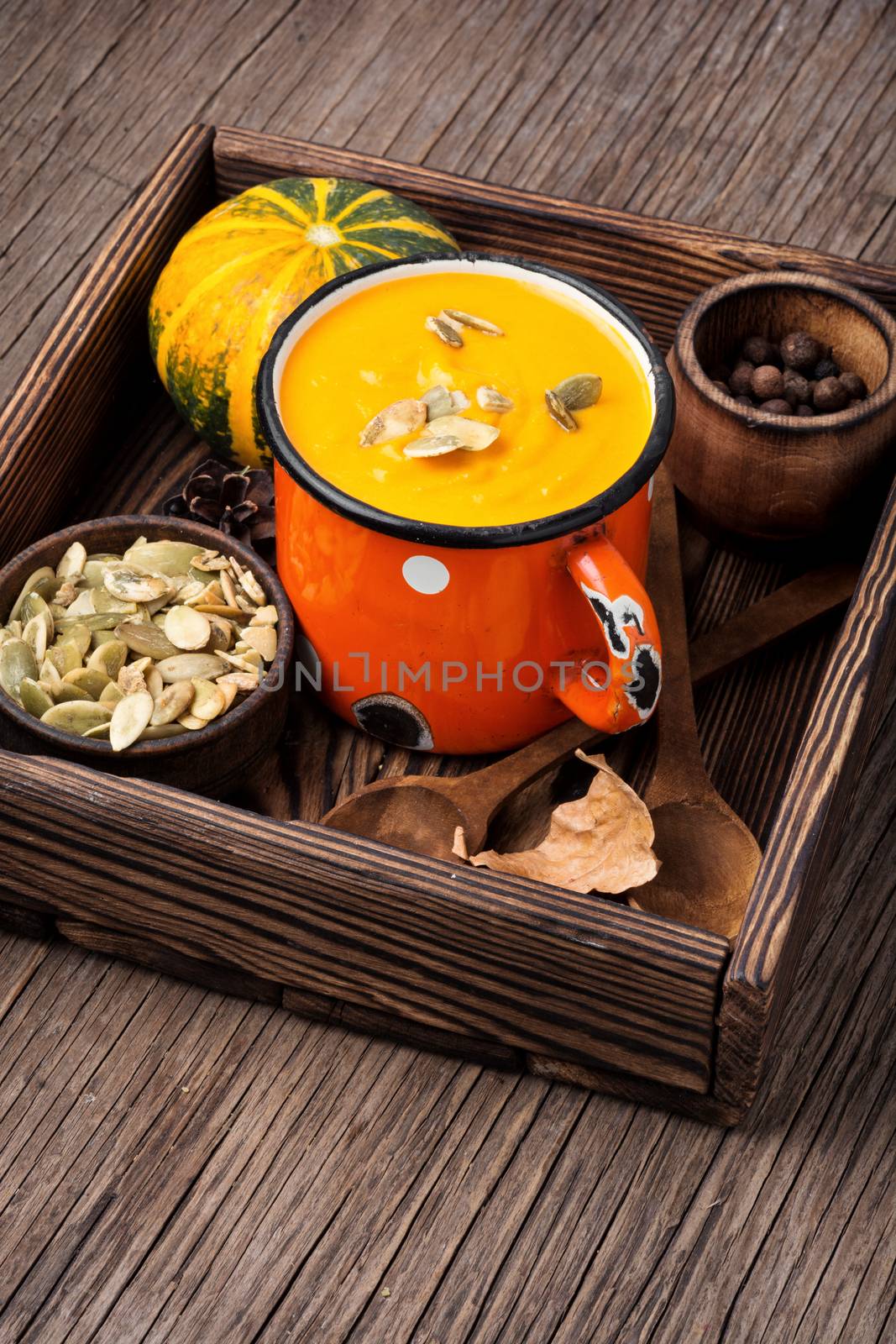 Autumn pumpkin soup in a metal cup. Autumn food