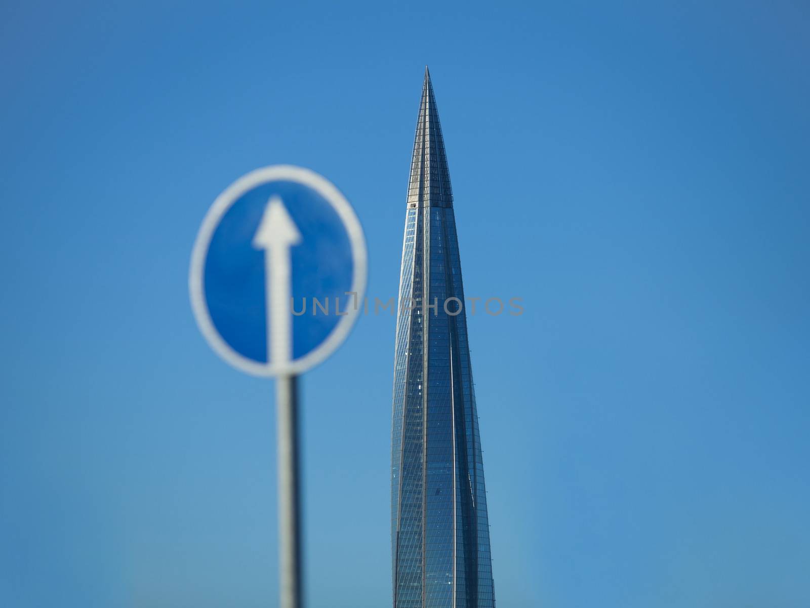 skyscraper spire and a Road sign white arrow up, concept of movement and business success
