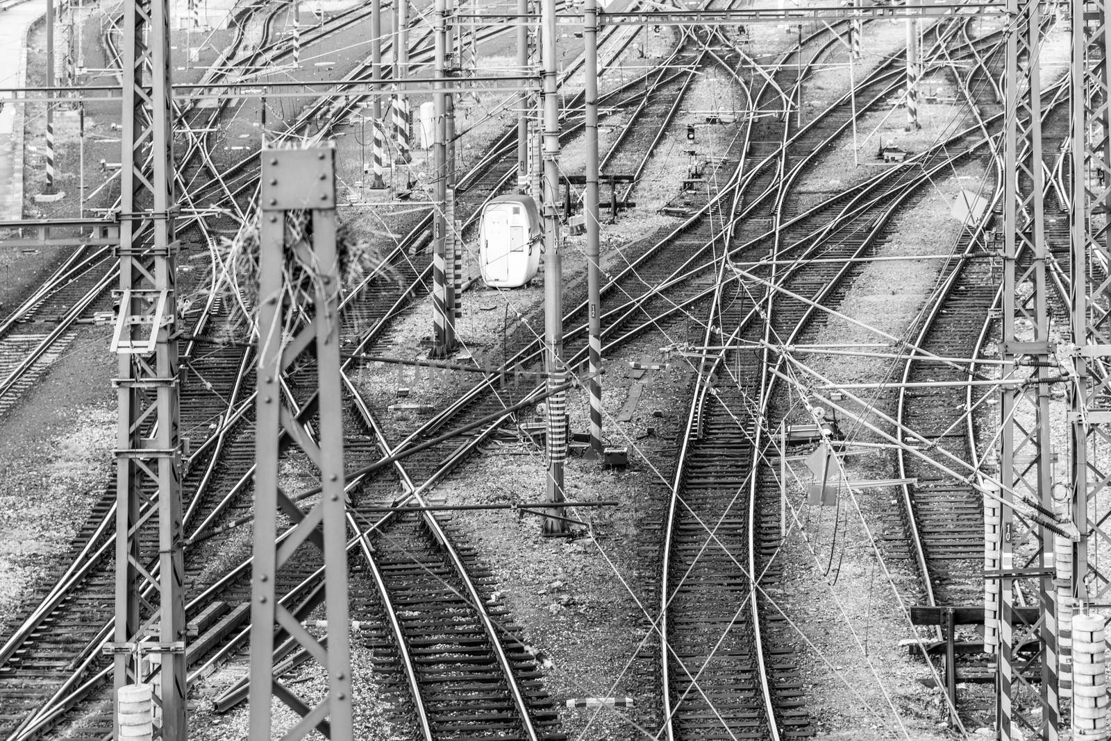 Railroad tangle at large train station. Railway transportation theme. Black and white image.