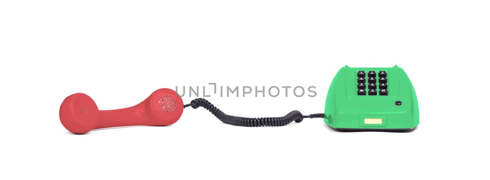 Vintage multi colored telephone with a white background