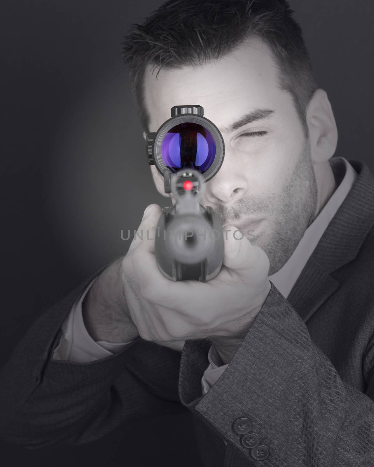 Man in suit with rifle and scope, isolated on black