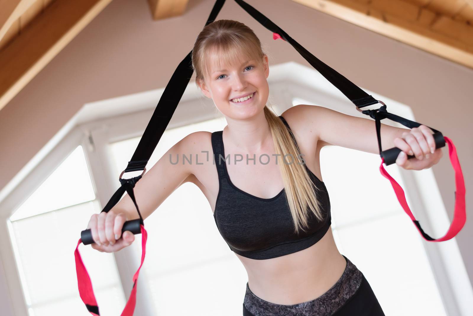Happy girl in sling training at home