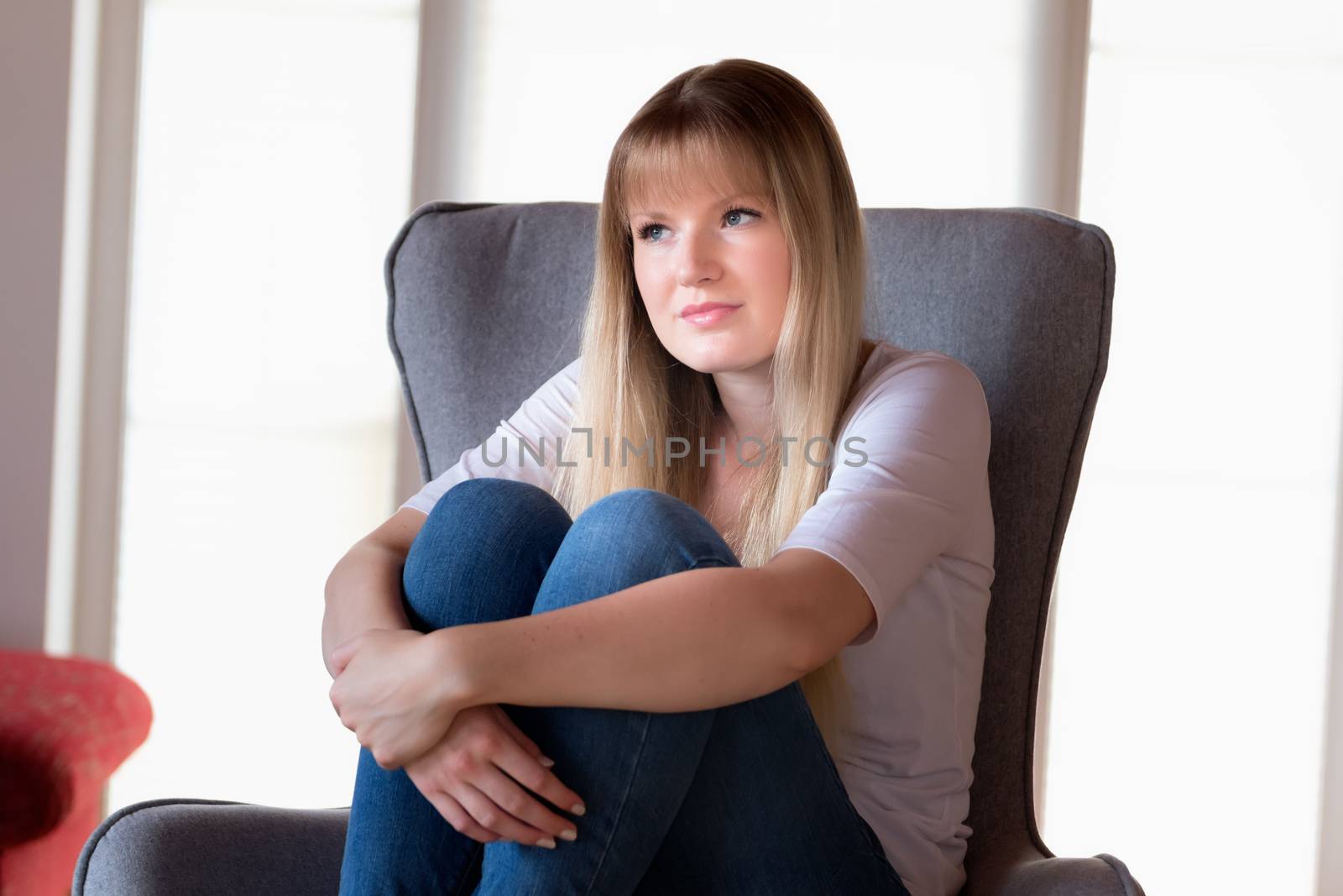 Sad girl sitting on chair by w20er