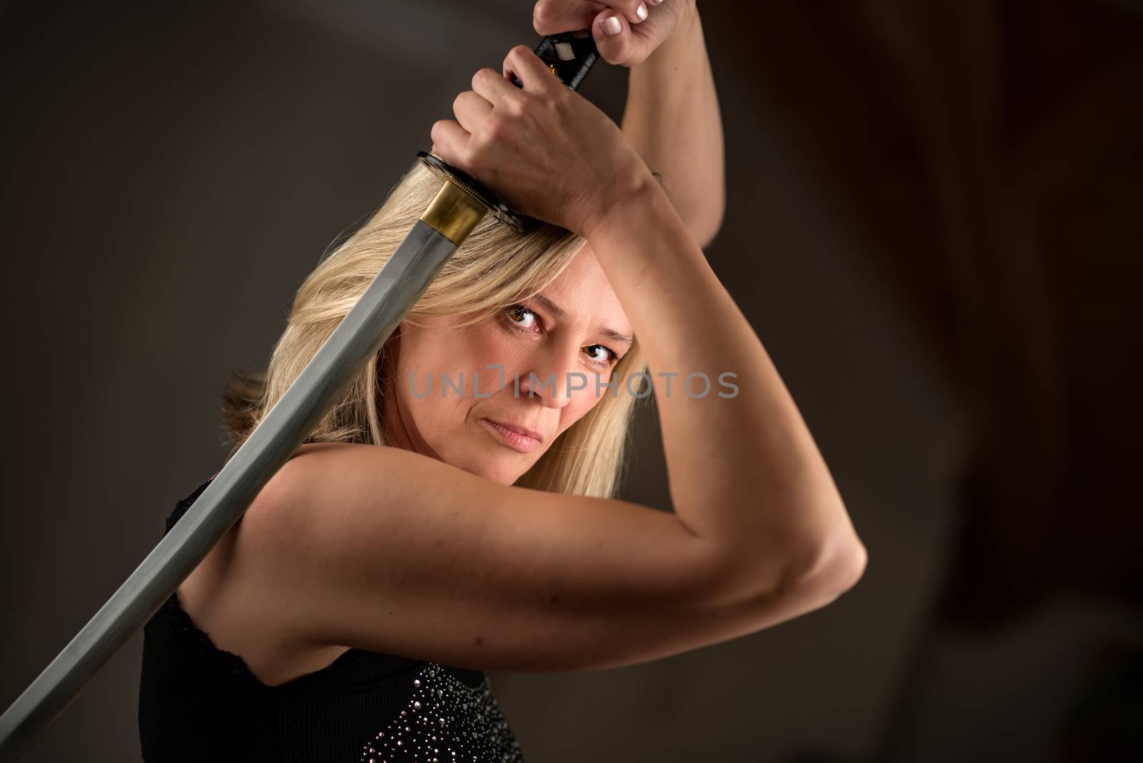 Strong female fighter with samurai sword in action