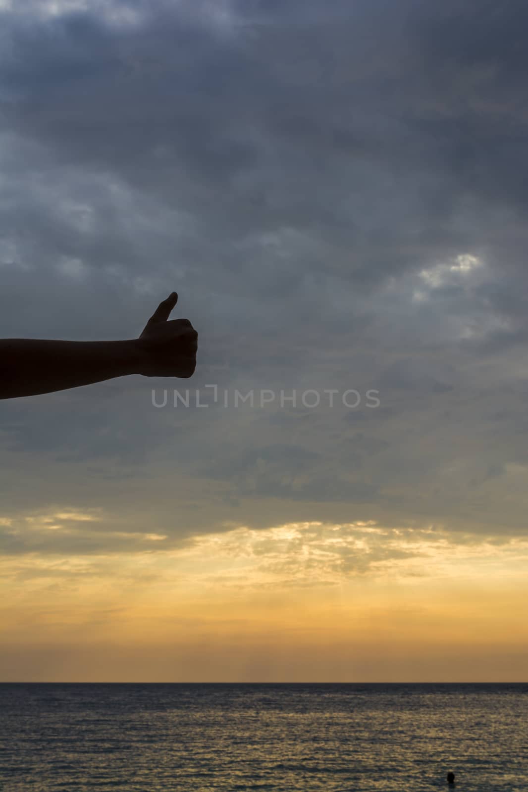 Hand at Sunset over Porto Katsiki (Lefkada island-Greece). One of the most impressive beaches from Lefkada is Porto Katsiki.