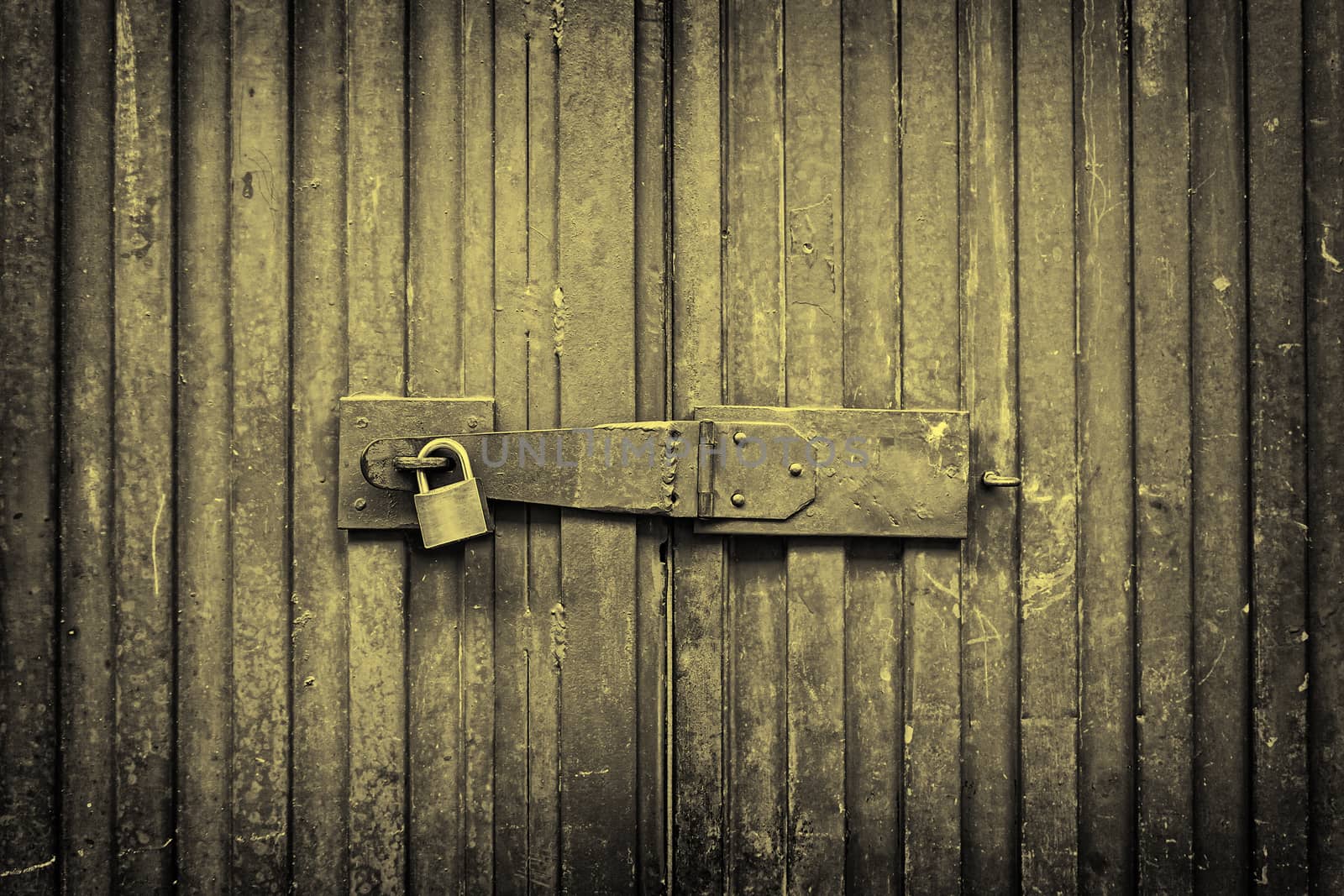 Blue door padlocked, detail of an old door painted blue, safety and security