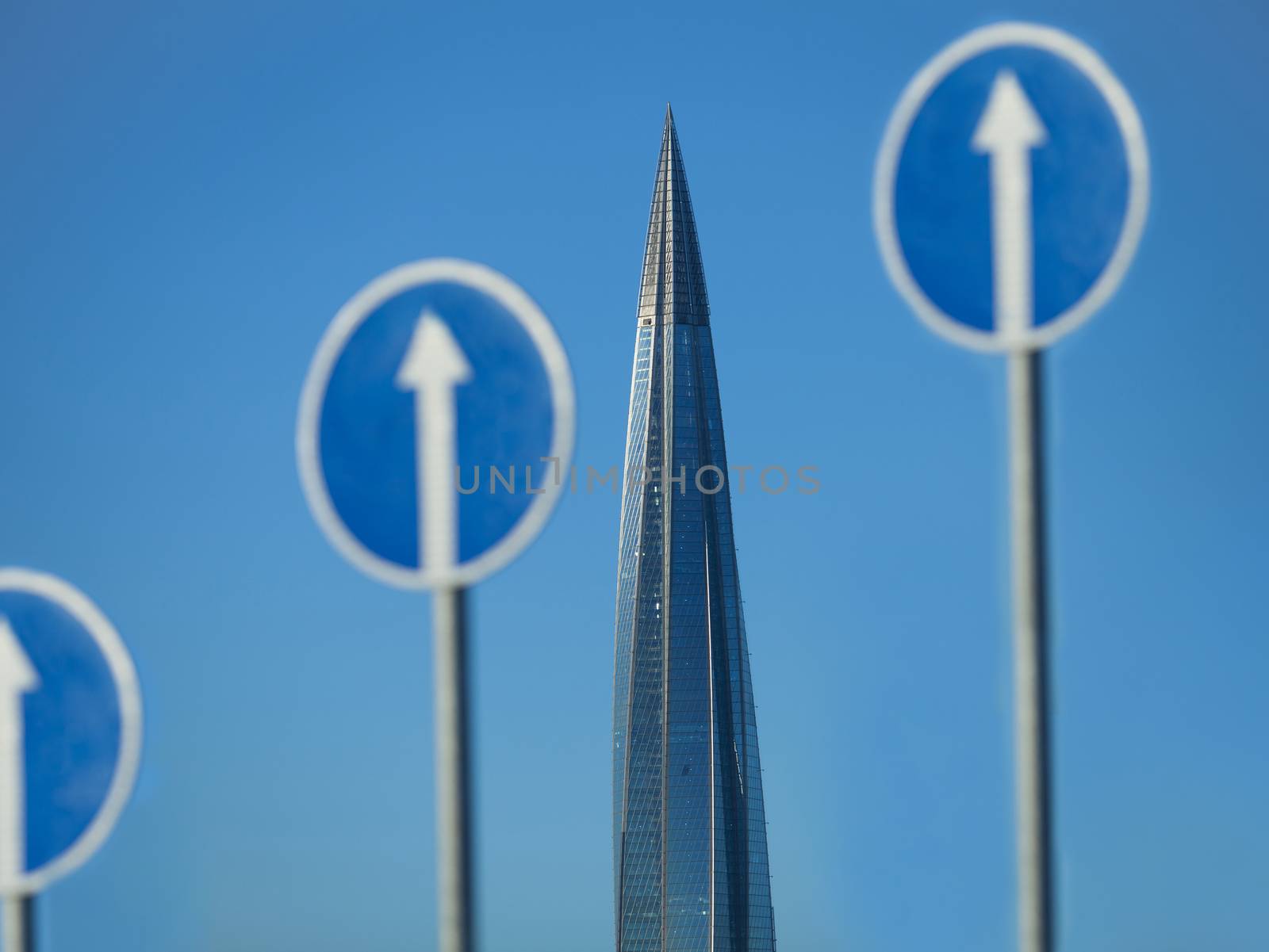 skyscraper spire and a Road sign white arrow up, concept of movement and business success