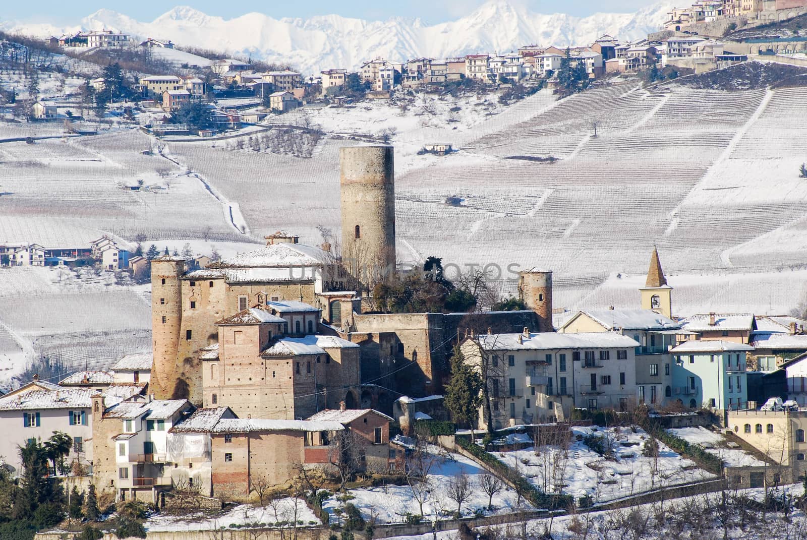 View of Langhe hills with snow and the village of Castiglion Falletto, Piedmont - Italy