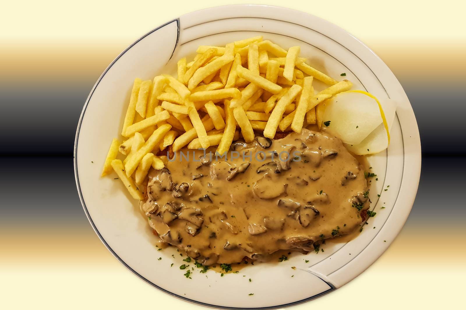 Jaeger Viennese schnitzel with French fries and mushrooms close-up on a plate. horizontal top view from above