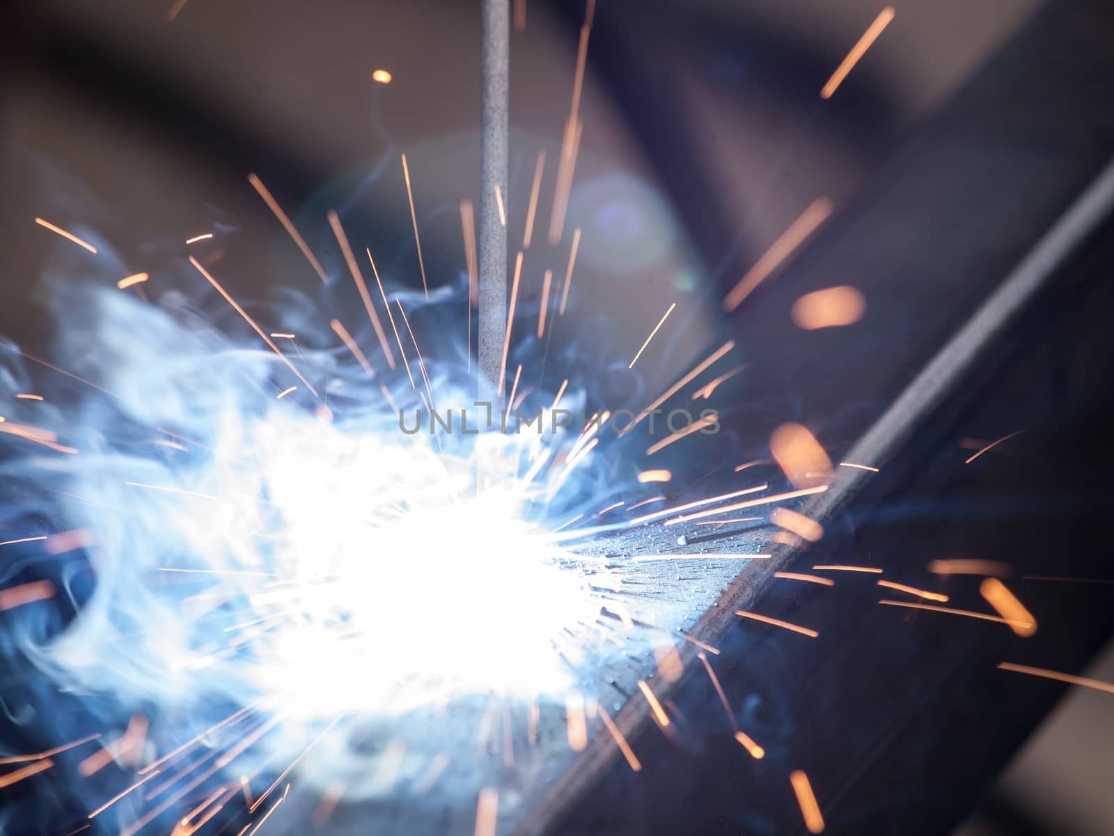 Close-up of electric welding spot producing high temperature and sparks