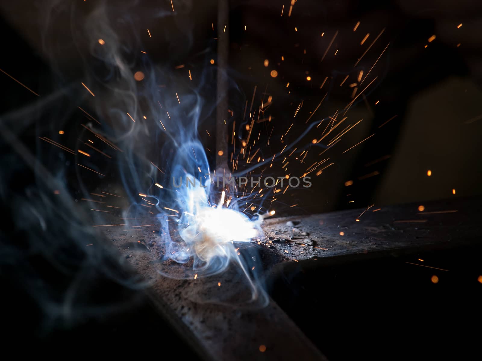 Close-up of electric welding spot producing high temperature and sparks