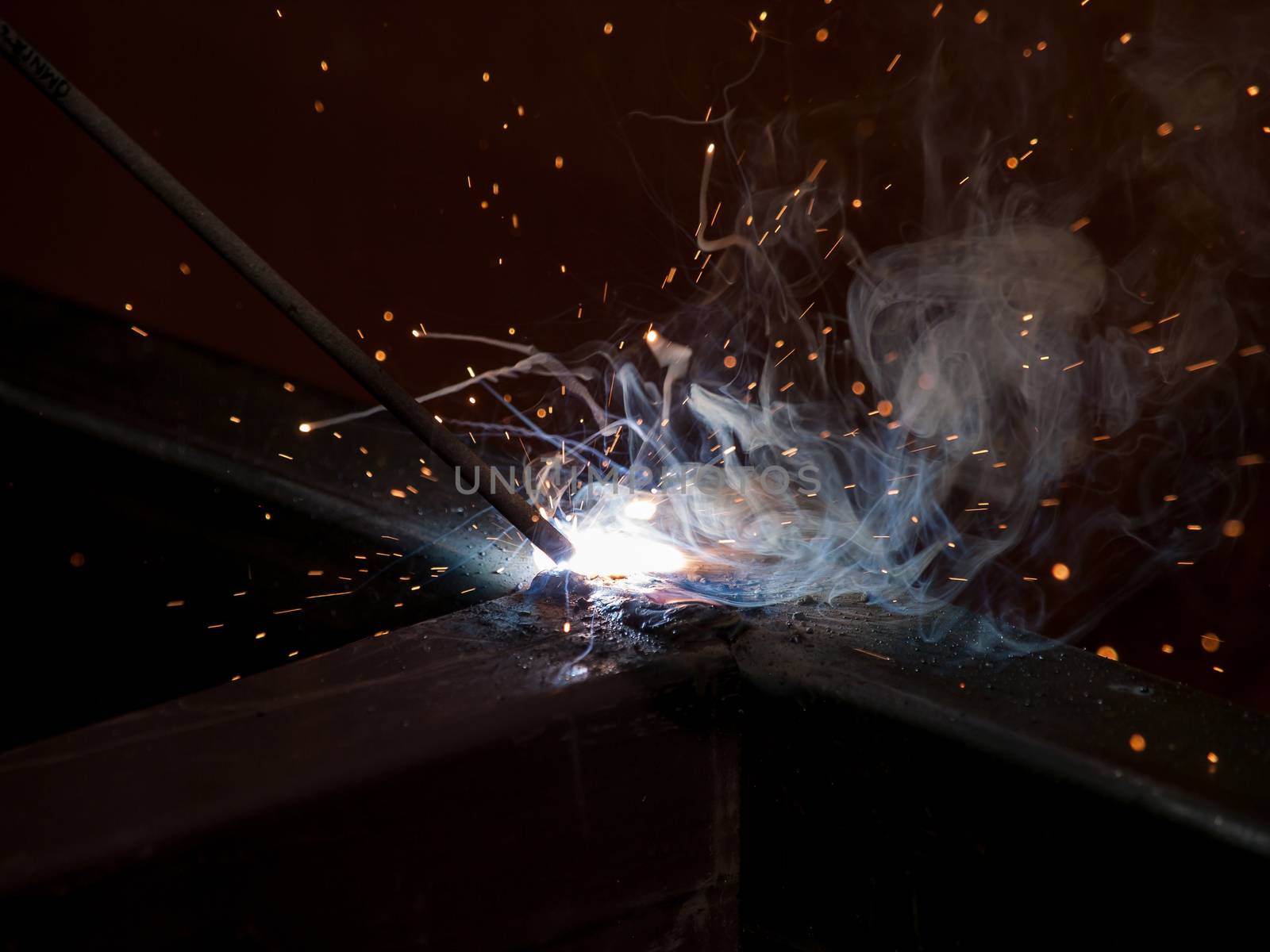 Close-up of electric welding spot producing high temperature and sparks