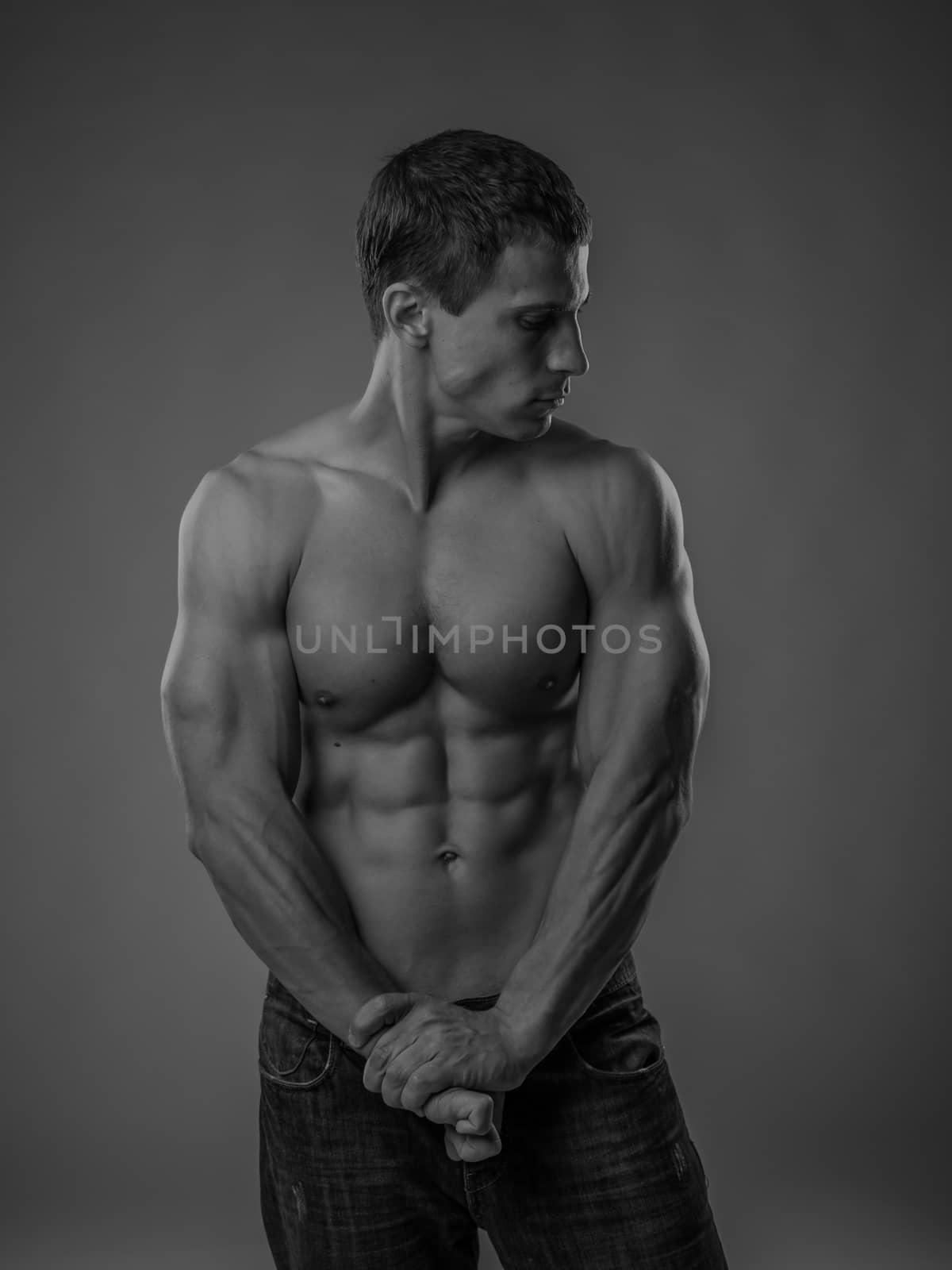 Muscular and fit young man posing shirtless