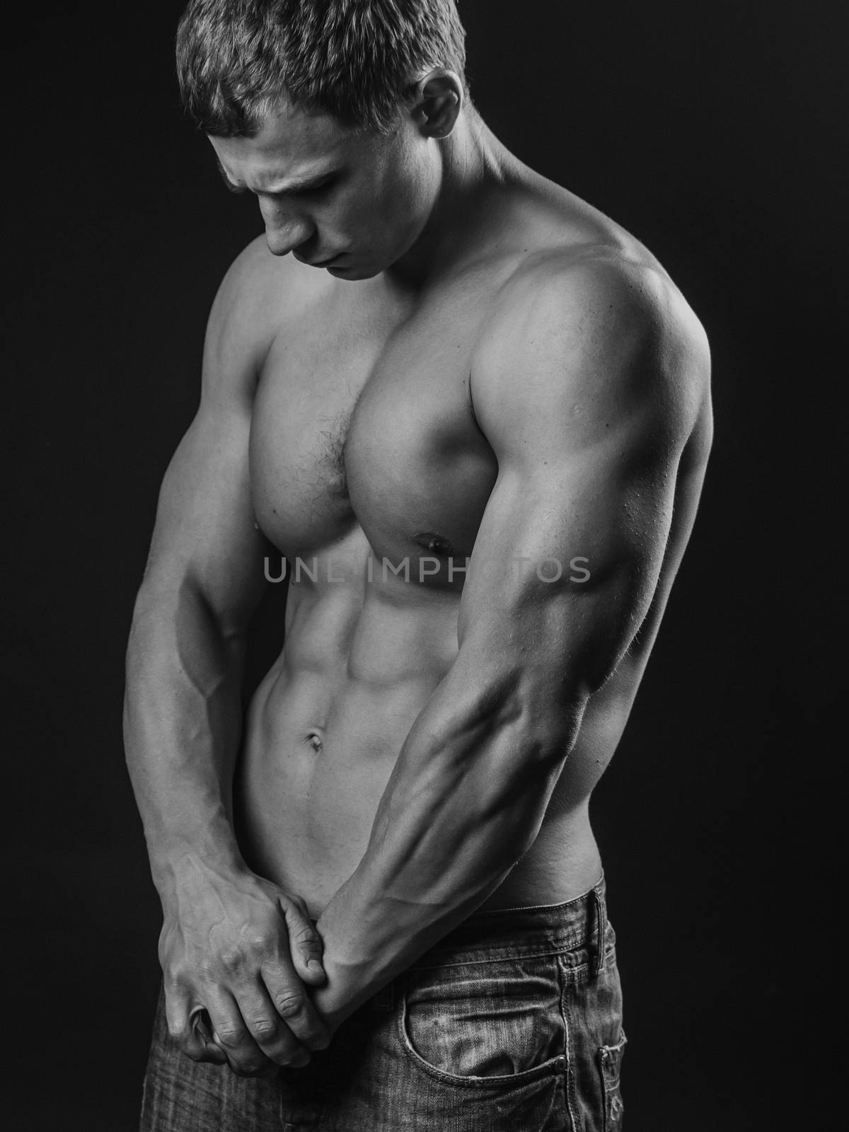 Muscular and fit young man posing shirtless