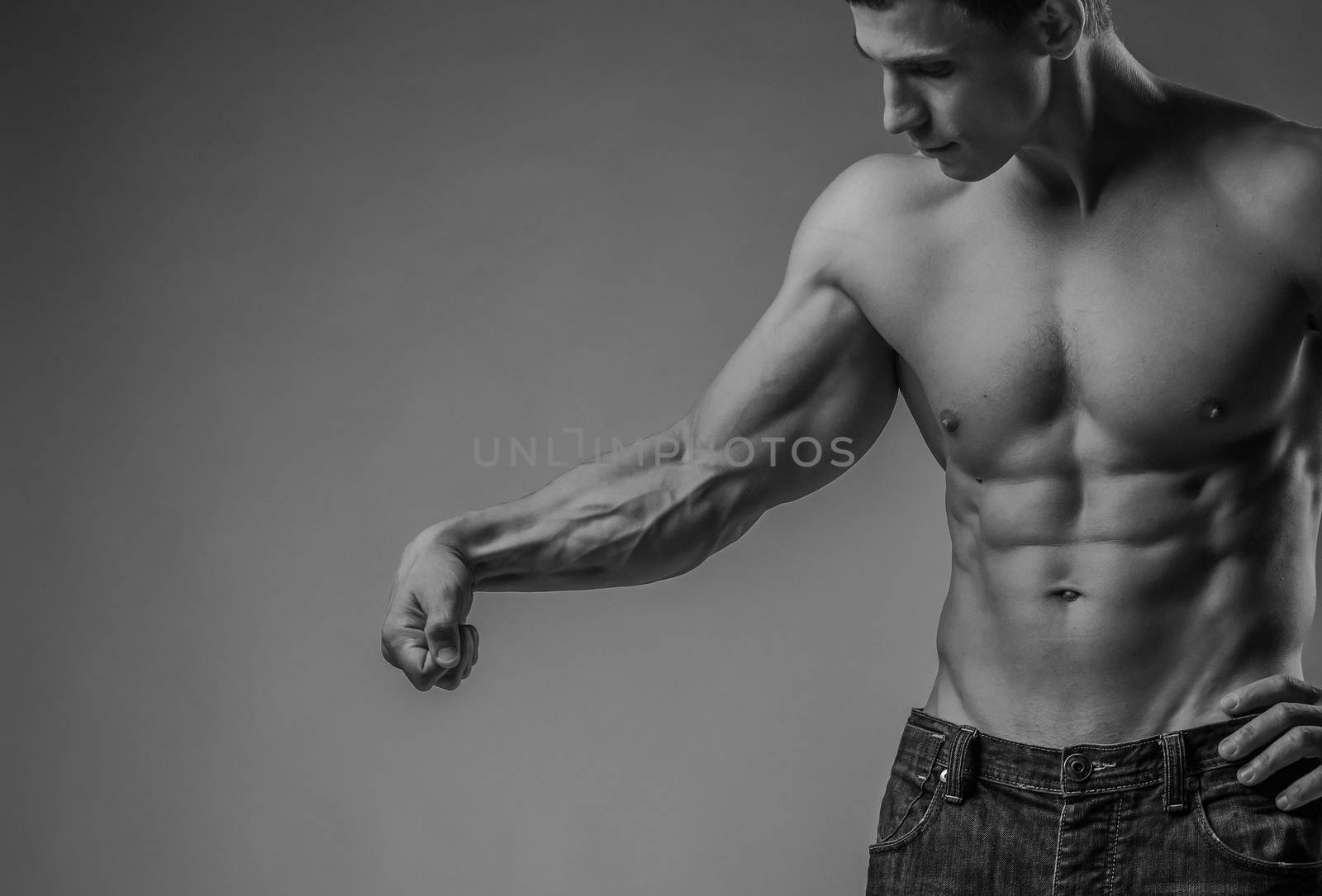 Muscular arm and torso of a perfectly fit young man
