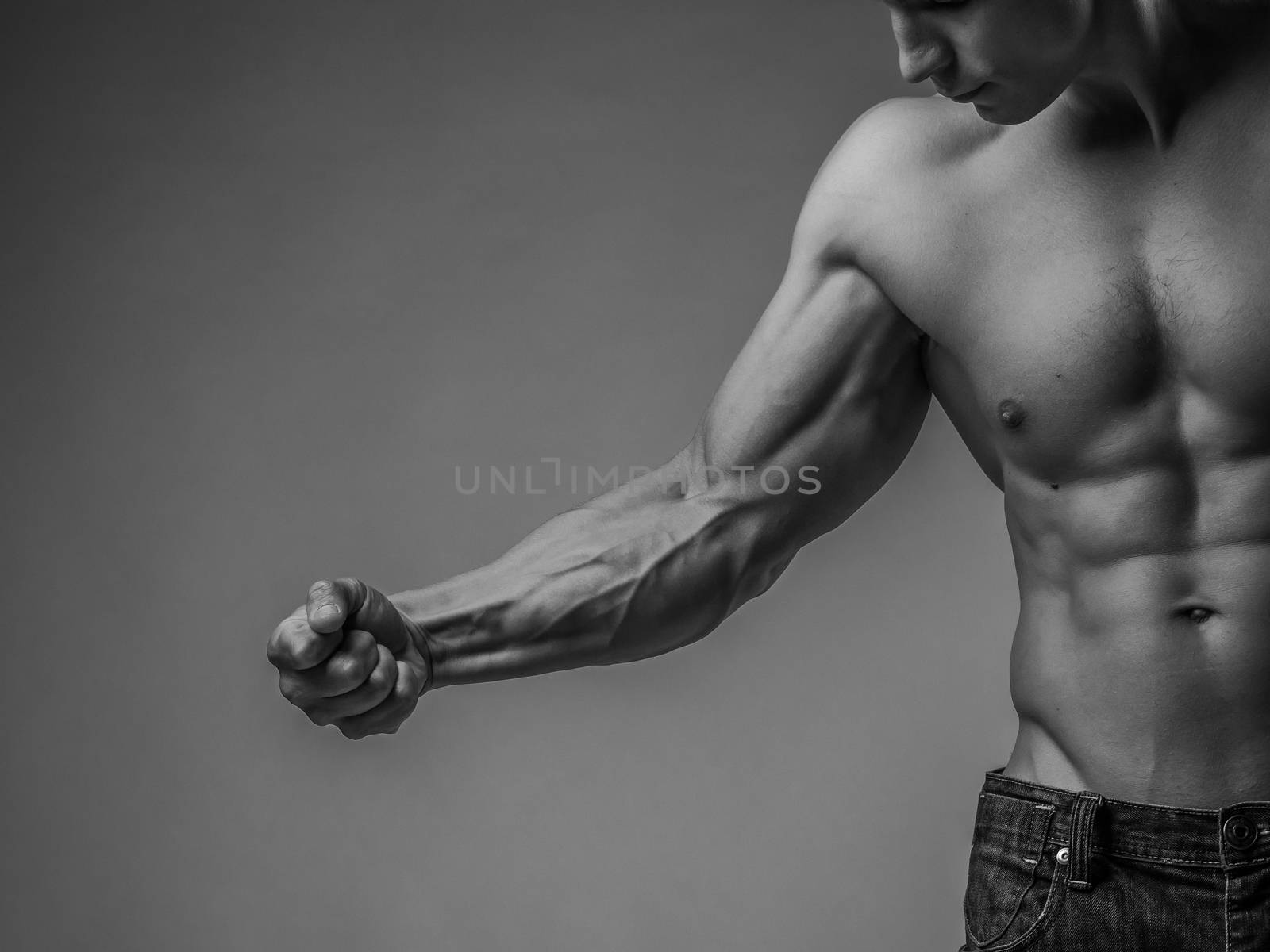 Muscular arm and torso of a perfectly fit young man