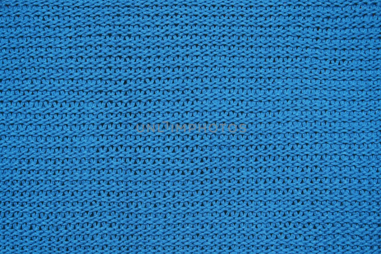 Blue knitted background of large knitting texture of knitted fabric
