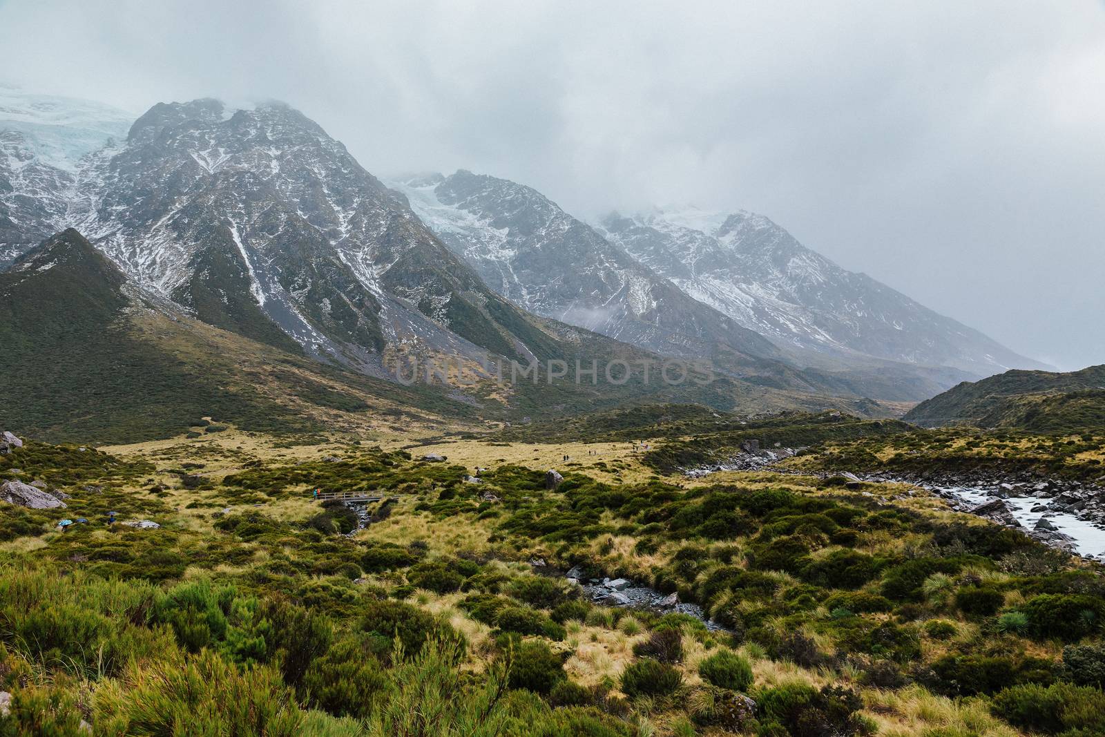Hooker Valley Track hiking trail, New Zealand. View of Aoraki Mount Cook National Park with snow capped mountains.