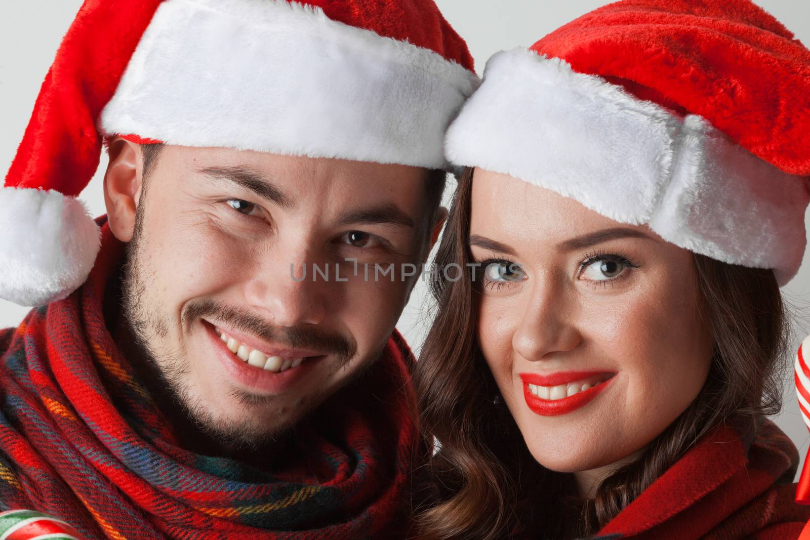 Young happy funny couple in christmas santa hats