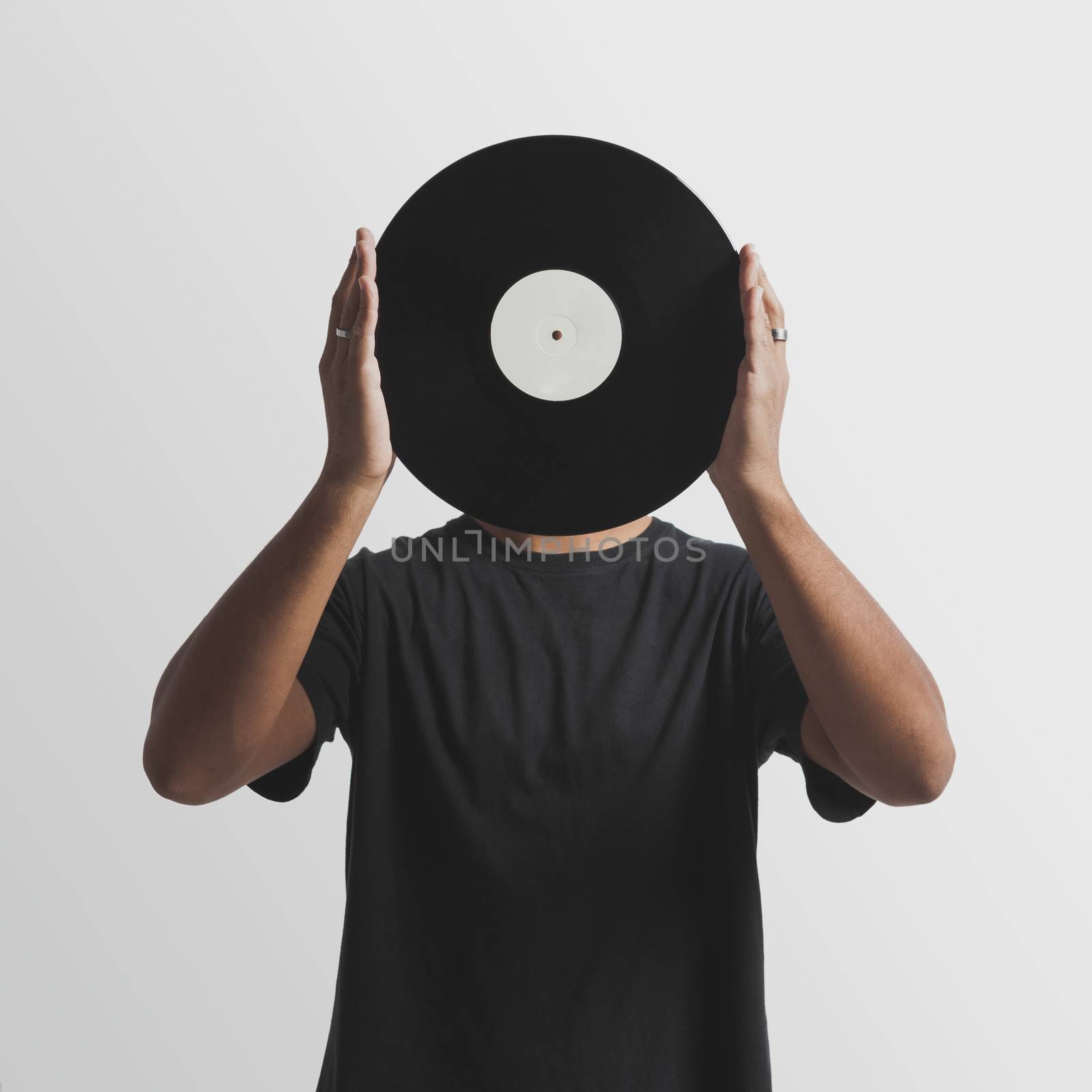 DJ holding a vinyl disk by Iko