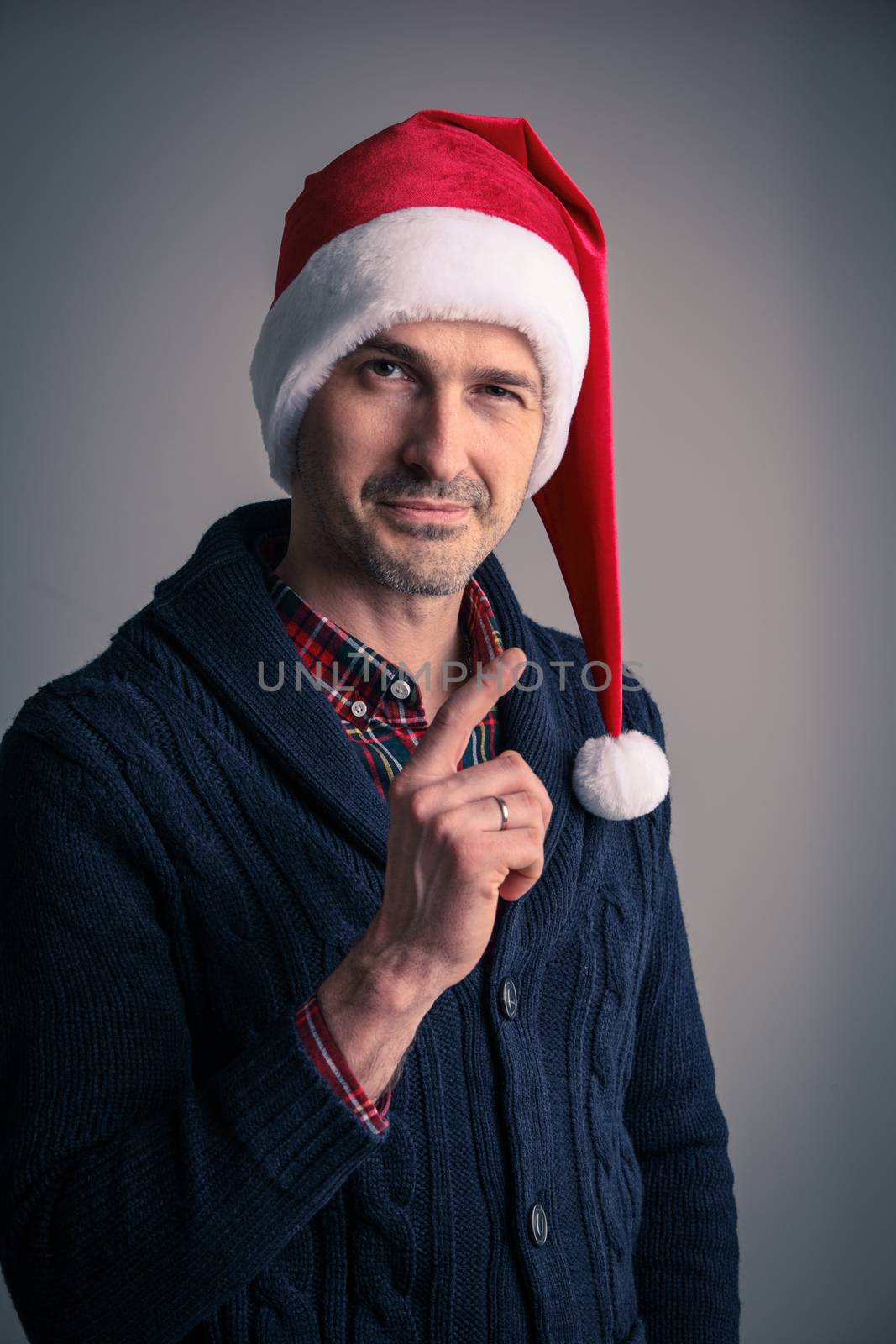 Man in santa hat raised his finger up by ALotOfPeople