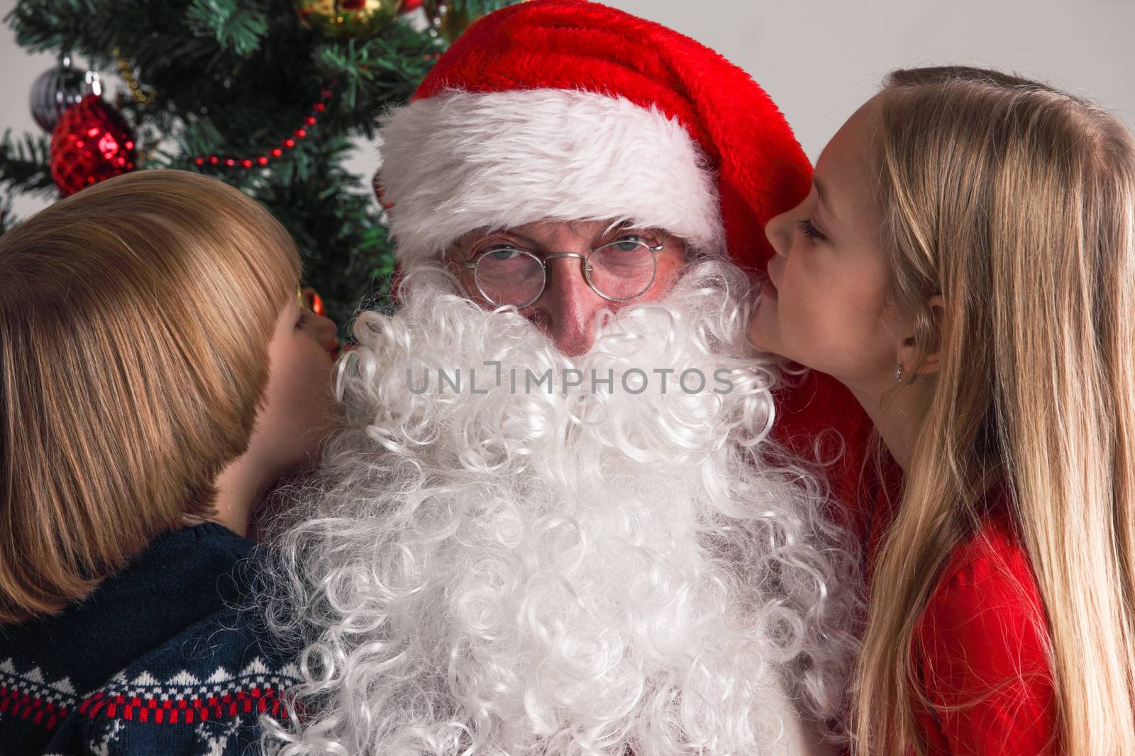 Two Children whispering to Santa Claus ear Suggesting desires