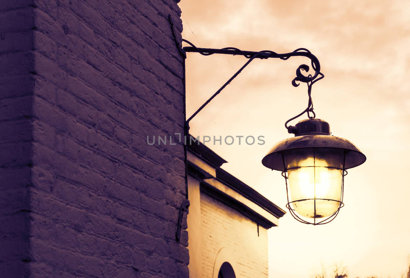 lighted old and dirty lantern shining bright light at night by charlottebleijenberg