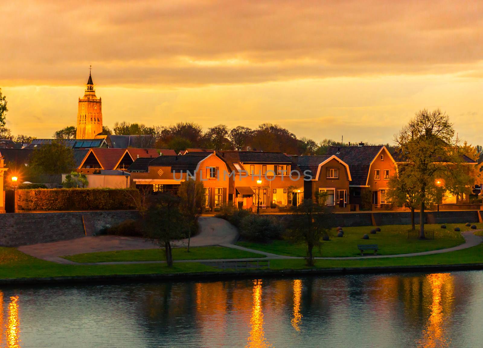 city skyline Leerdam the netherlands at sunset with water and park view by charlottebleijenberg