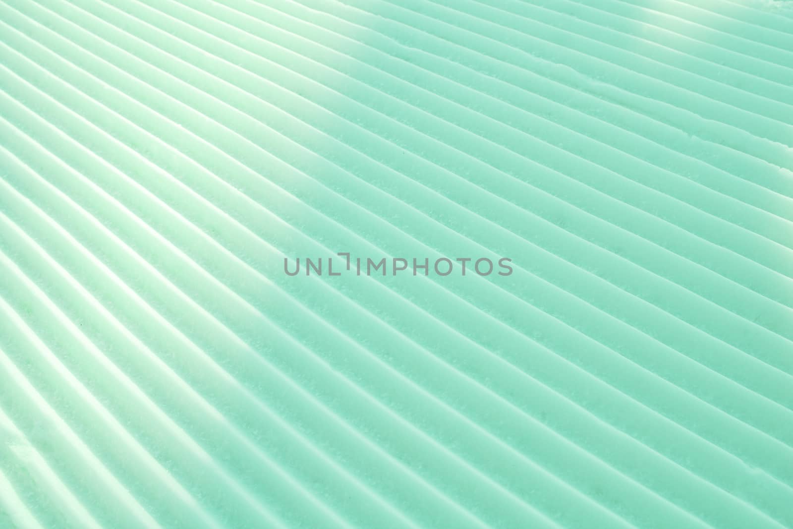 Background of diagonal geometrical parallel stripes of snow colored with light shade