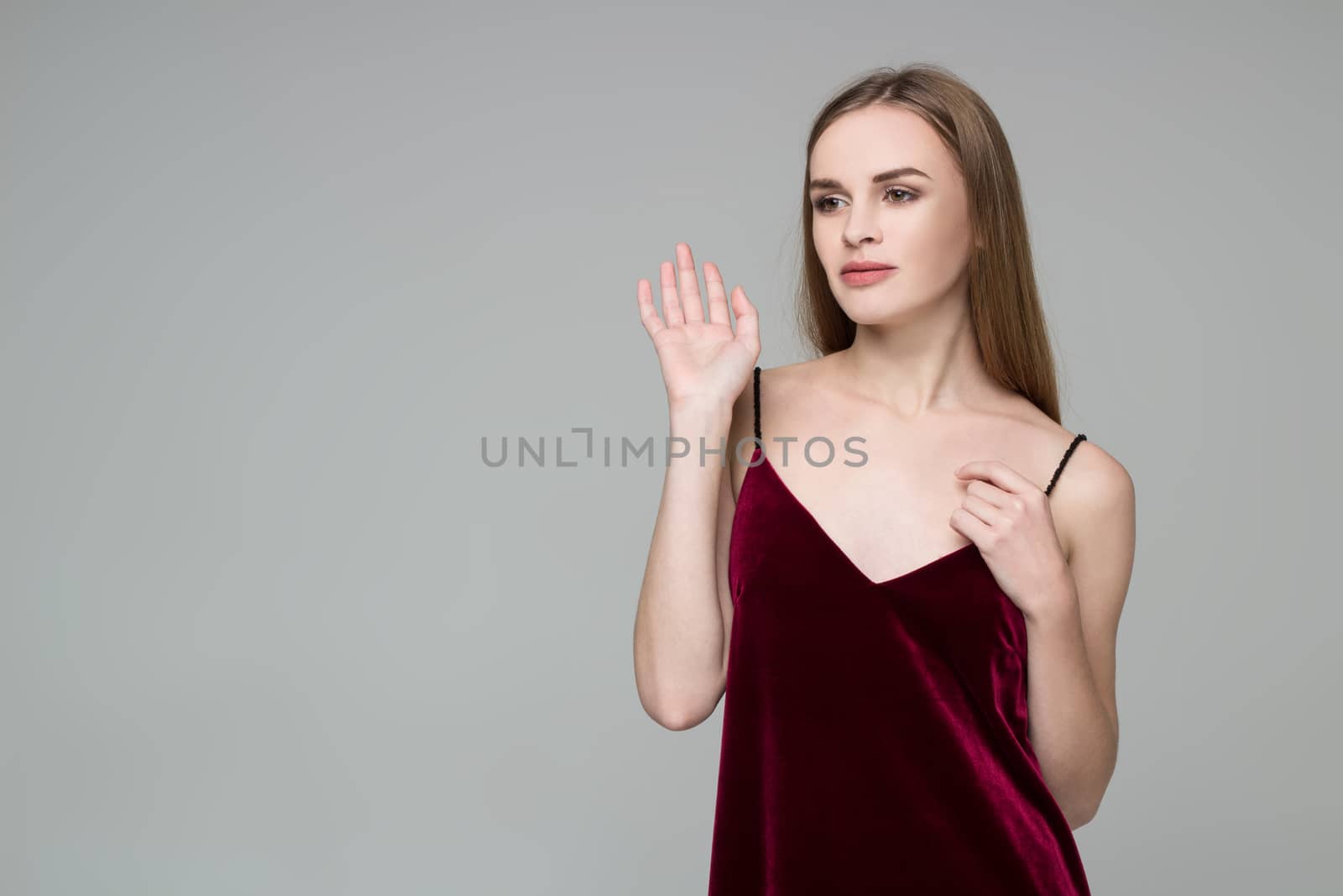 Young blond girl in dark red dress showing emotions: greeting by VeraVerano