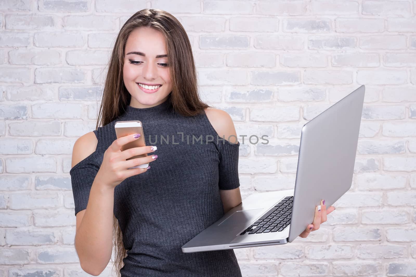 Female long-haired  business manager with notebook and telephone by VeraVerano