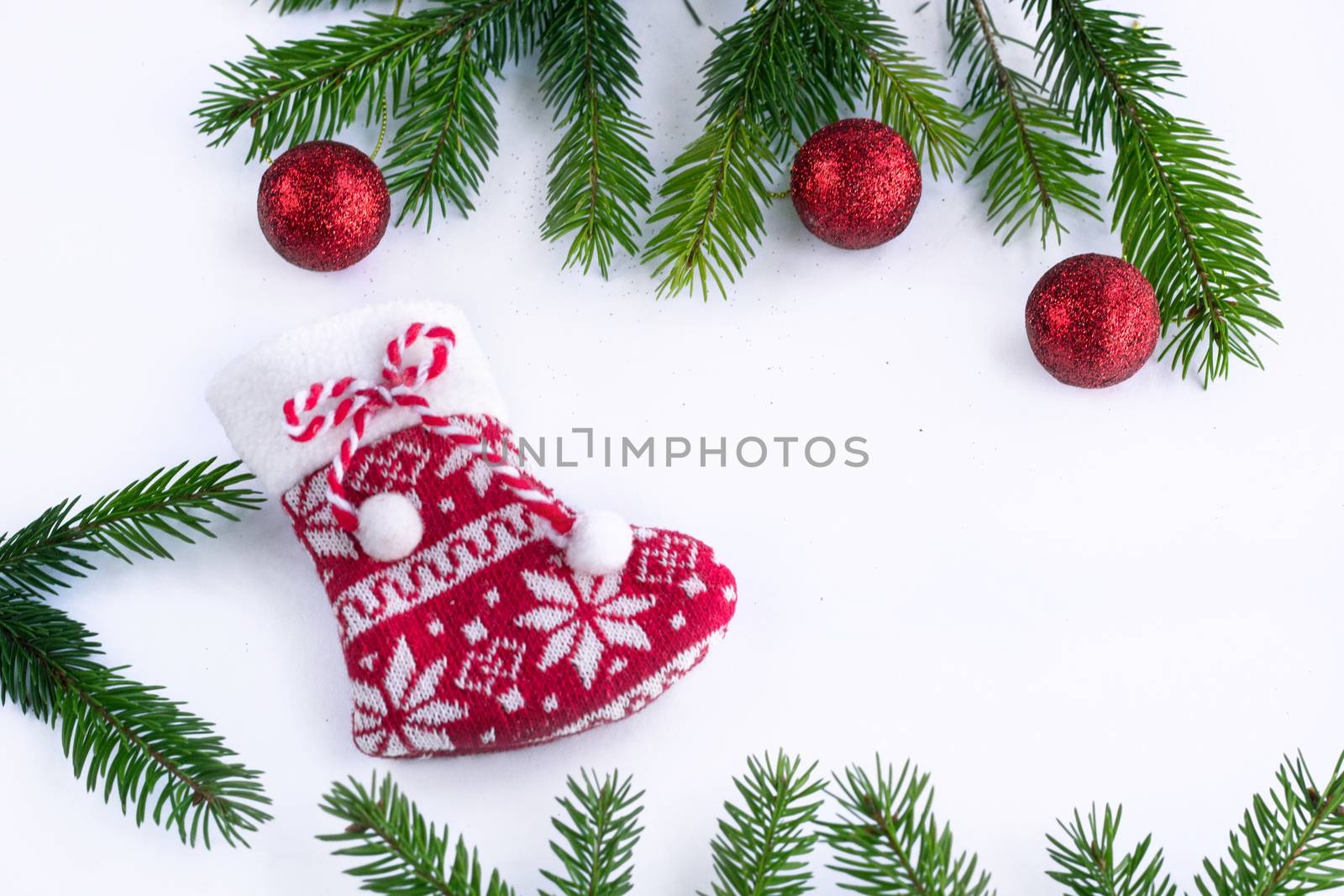 Red Christmas sock and decoration balls on white background, fra by VeraVerano