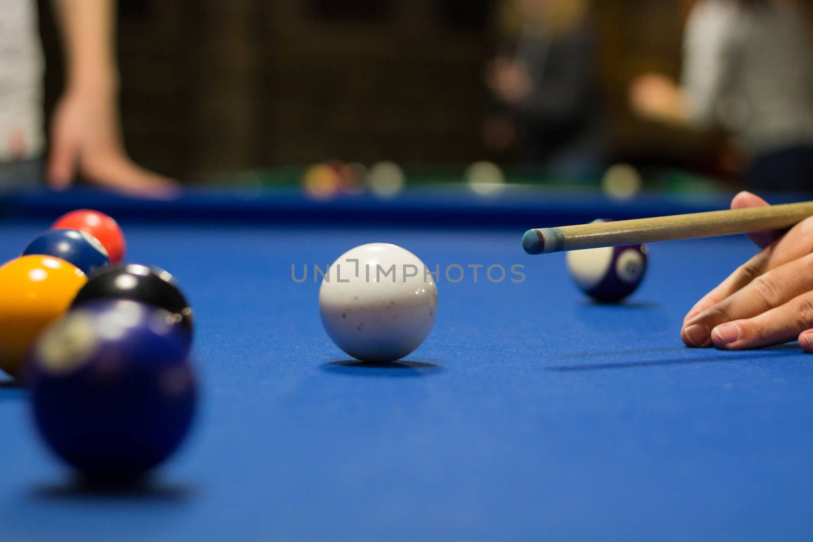 Billiard pool game player aims to shoot balls with cue by VeraVerano