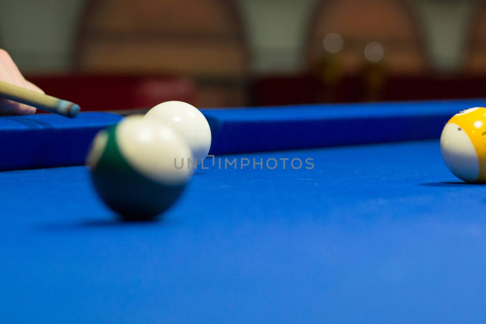 Billiard pool player aims to shoot balls with cue by VeraVerano