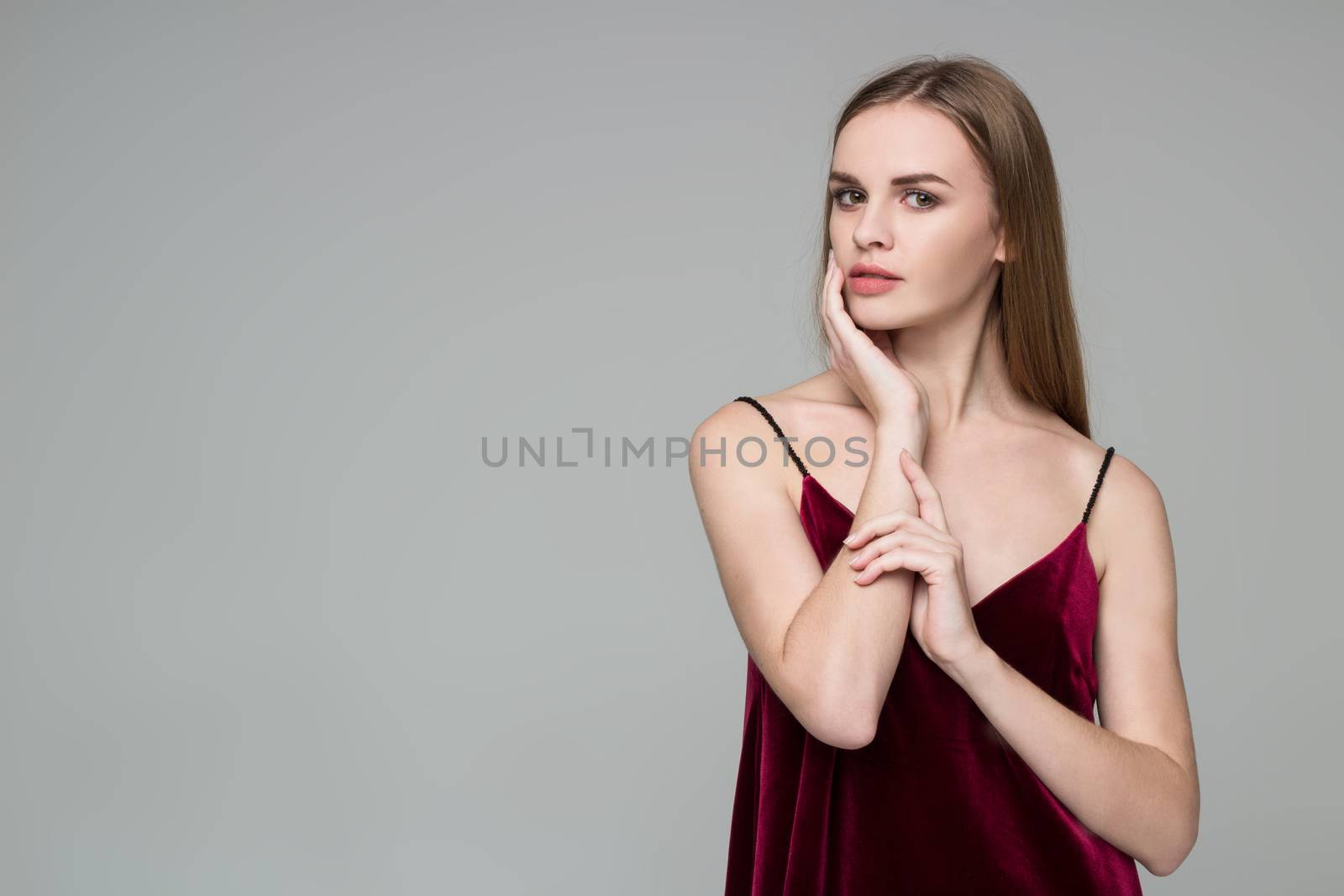 Blond girl in red dress poses showing emotions: wistfulness, mus by VeraVerano