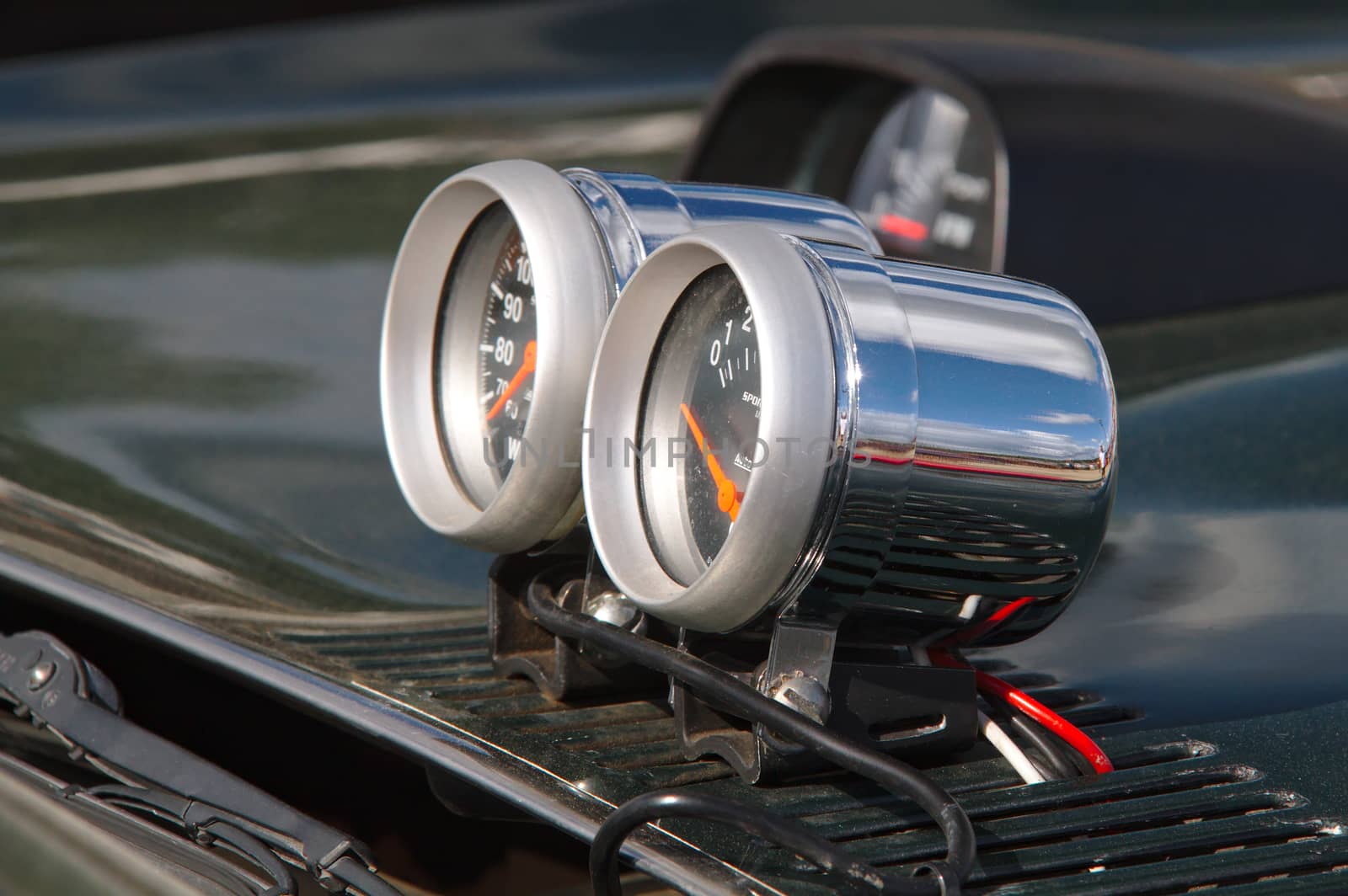 External gauges outside on the hood of a modified car.