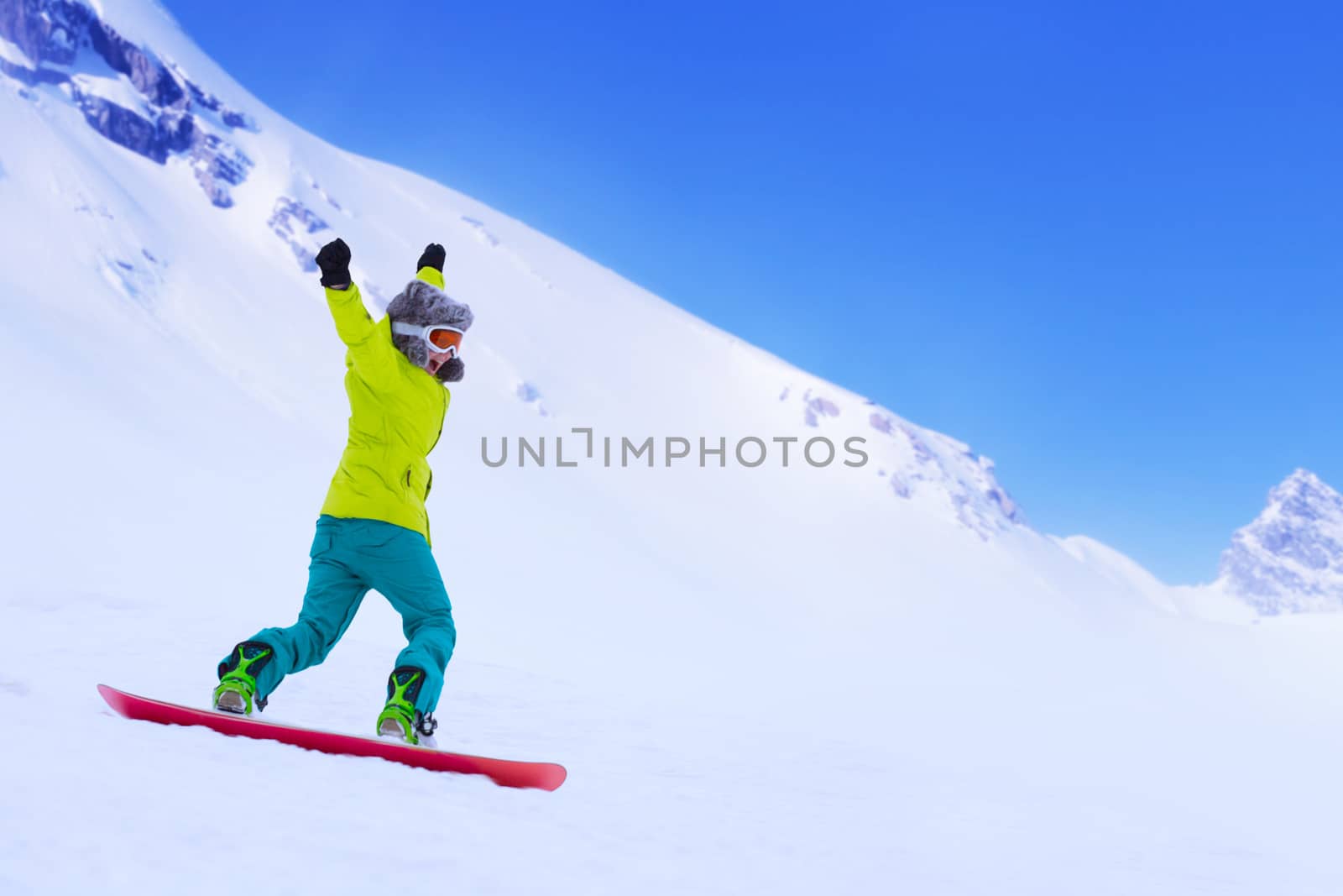 Snowboarder running down slope by destillat