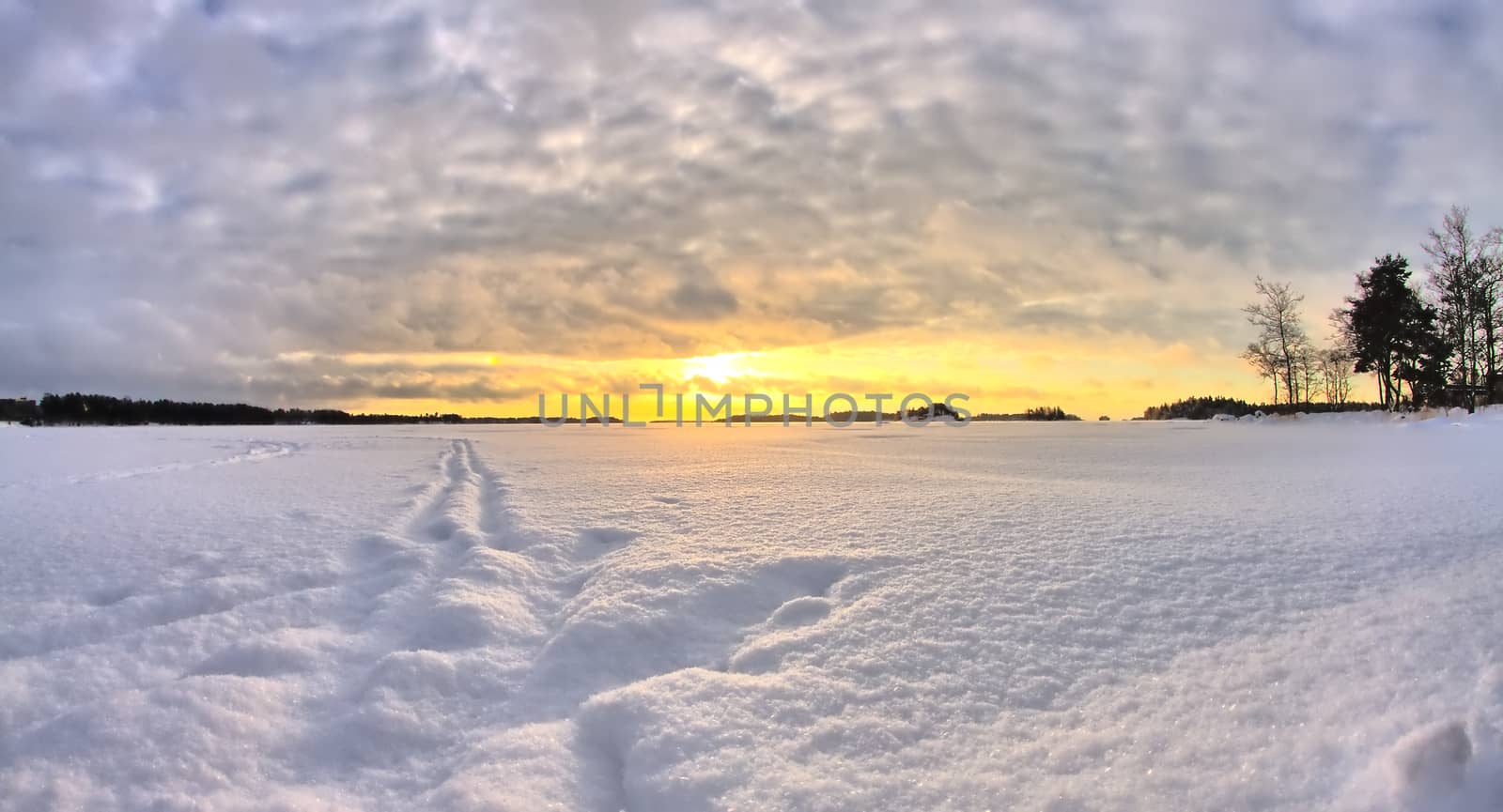 Deep snow on frozen sea in the north. Beautiful cold winter morning sunrise HDR.
