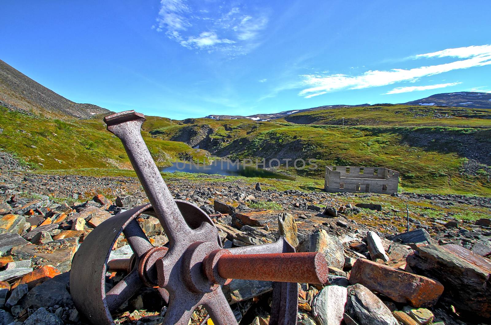Old broken flywheel of an abandoned copper mine in the mountains.