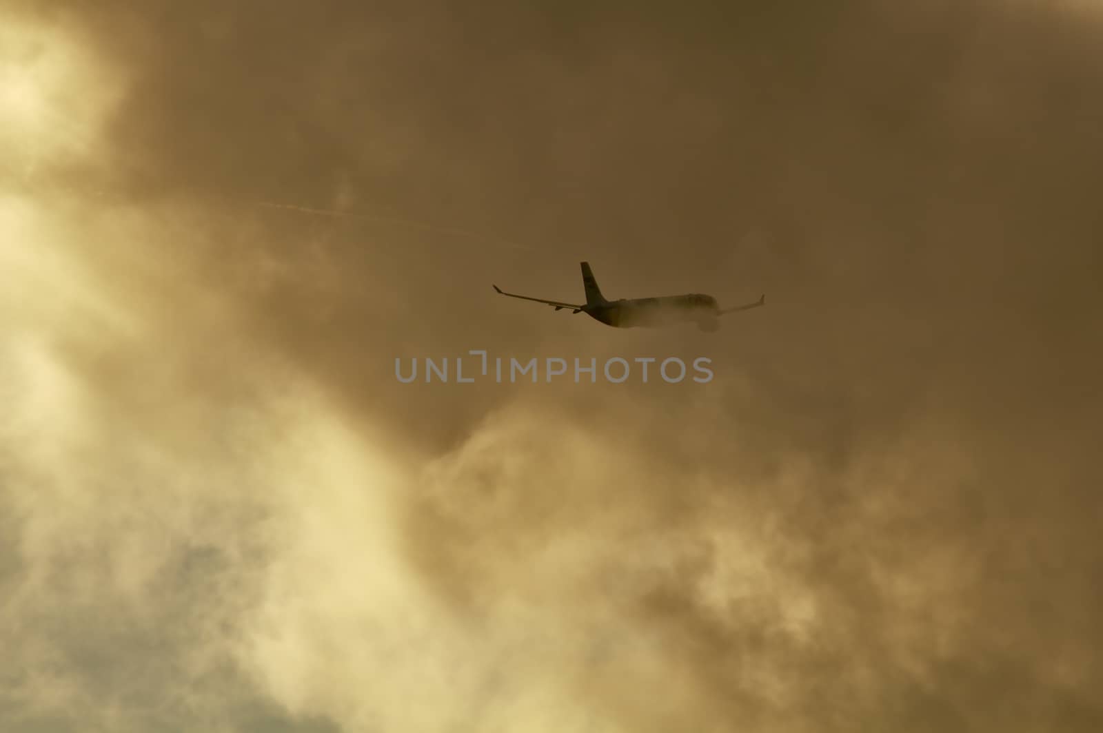 Commercial airplane disappears as it enters into the huge clouds.