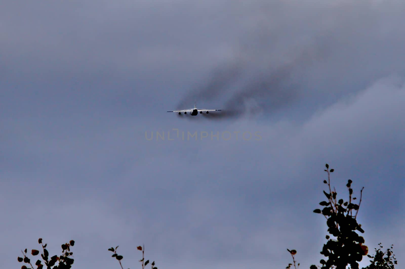 Excessive black smoke from engines of a four engine cargo plane after takeoff. Some planes are more environment friendly than others.